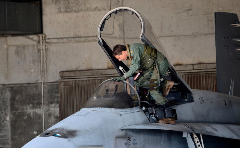 El piloto de un F-18 de la Fuerza Aérea de España completamente armado sube para despegar en una patrulla de la OTAN.