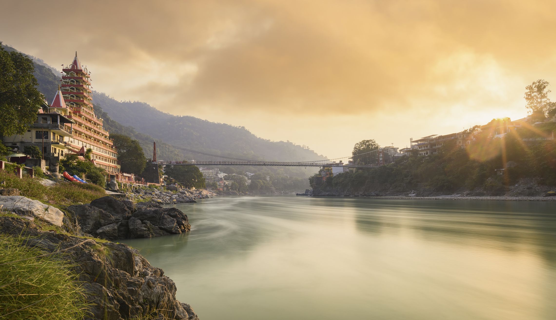 <p>Rishikesh is known as the Yoga Capital of the world. Millions of people flock to this quaint town at the foot of the Himalayan foothills every year.</p><p>Rishikesh is a yoga base camp for sadhus – holy men who live in ashrams on the banks of Hinduism’s most sacred river, the Ganga. They have mastered the art of meditation over the centuries and live a peaceful life with few possessions.</p><p><em>“The Ganga River is considered the holiest river because the Hindus believe it is the body of the Goddess Ganga, a deity who came to earth to purify souls. You can swim in the river, and many Hindus believe life isn’t complete without bathing in it at least once.”</em> – Nick Kembel from <a href="https://funworldfacts.com/">Fun World Facts</a>.</p><p>If you do decide to go to Rishikesh, you can stay in either Ram Jhula or Lakshman Jhula, both of which have plenty of affordable hotels and yoga centers. It’s a truly peaceful place with friendly locals, cheap food, and plenty to do.</p><p>If you’re looking for adventure on your spiritual retreat, you can go white water rafting, hike to waterfalls, and even cliff jumping. But if you want something calmer, you can find a yoga teacher and practice some quiet meditation instead.</p>