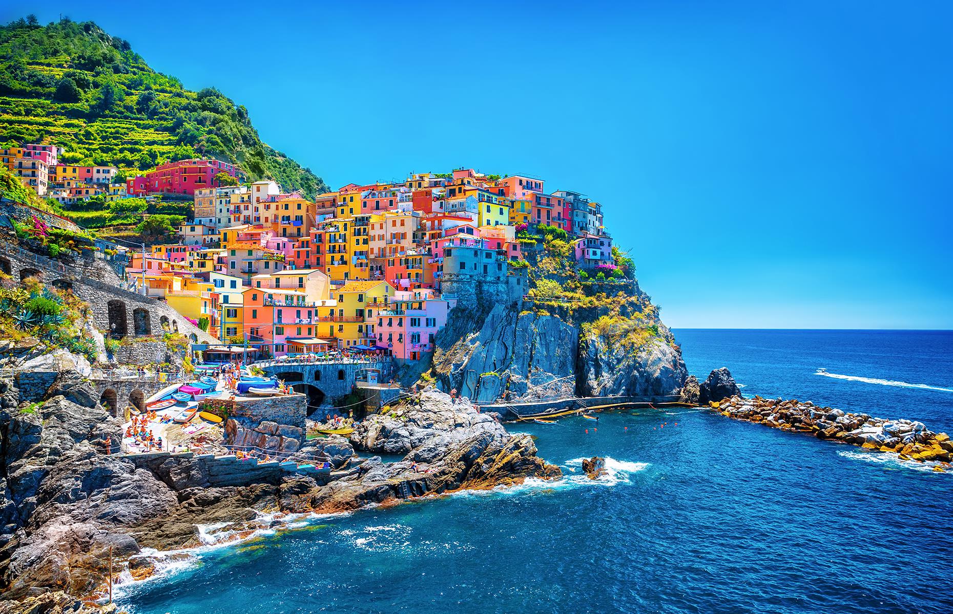<p>Set on the rocky coastal cliffs of northwestern Italy, Manarola is one of the five fishing villages that make up Cinque Terre – one of the world's most colorful destinations. The homes are said to have been painted in bright shades of blue, pink, yellow and orange so that the returning fishermen could spot their homes easier. </p>  <p><a href="https://www.loveexploring.com/galleries/108696/italys-most-beautiful-towns-and-villages?page=1"><strong>Here are Italy's most beautiful small towns and villages</strong></a></p>