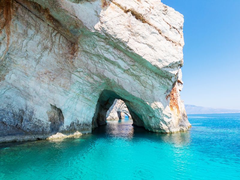 White rock with an archway in the ocean