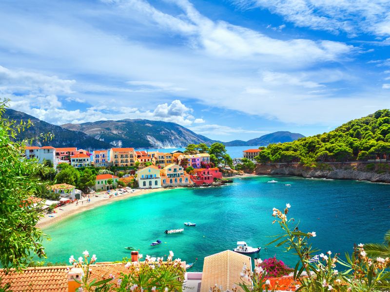 Kefalonia, lagoon with colorful buildings and lush greenery around