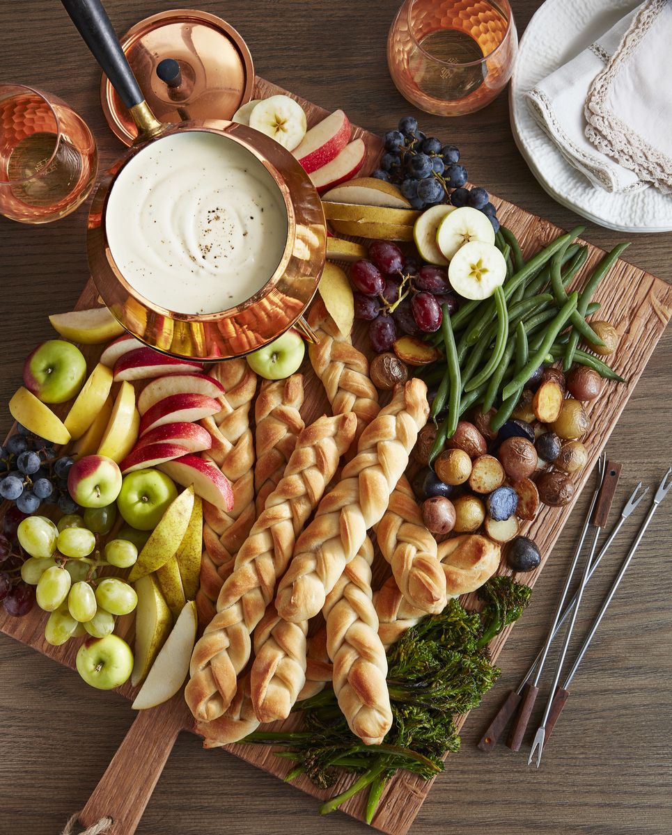 <p>Wine and cheese, but make it fondue. Artfully arrange bread, veggies, fruits, and meats of your liking on a breadboard, stock up on some wine, and you've got the makings for a warm and cozy 50th birthday celebration. </p>