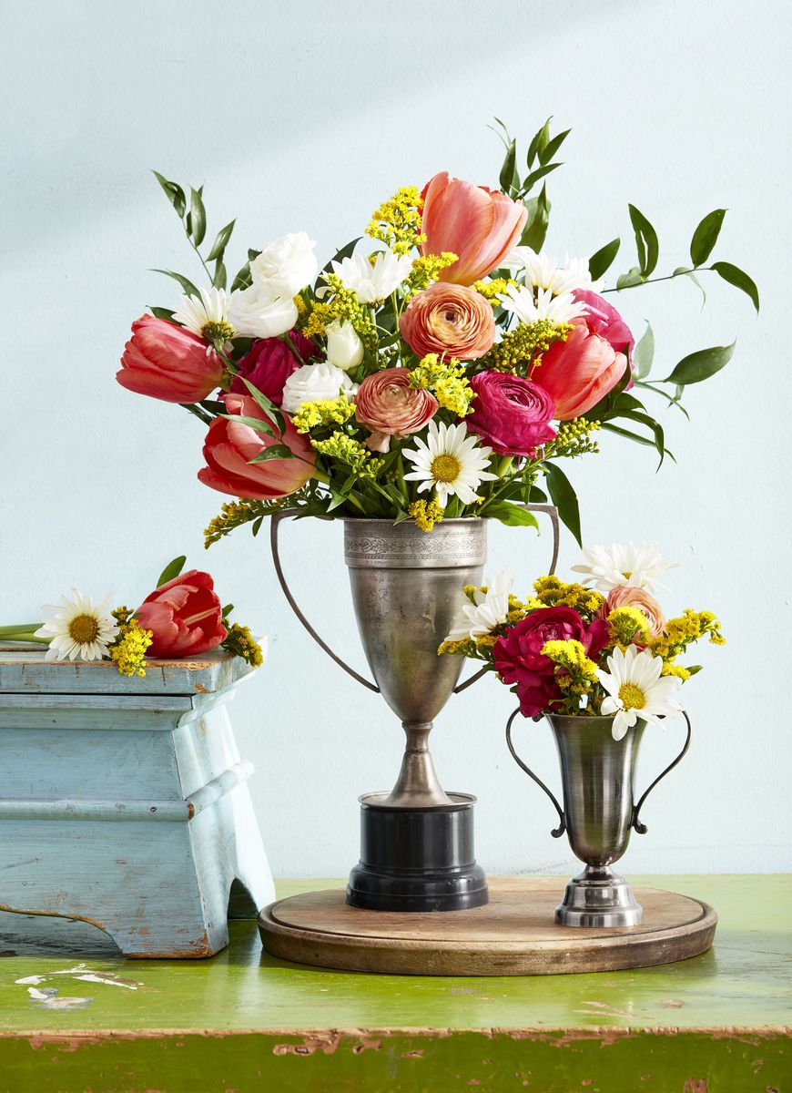 <p>#winningat50! Put your celebratory vintage trophy collection to good use by using them as vases on your buffet and dinner table.</p>