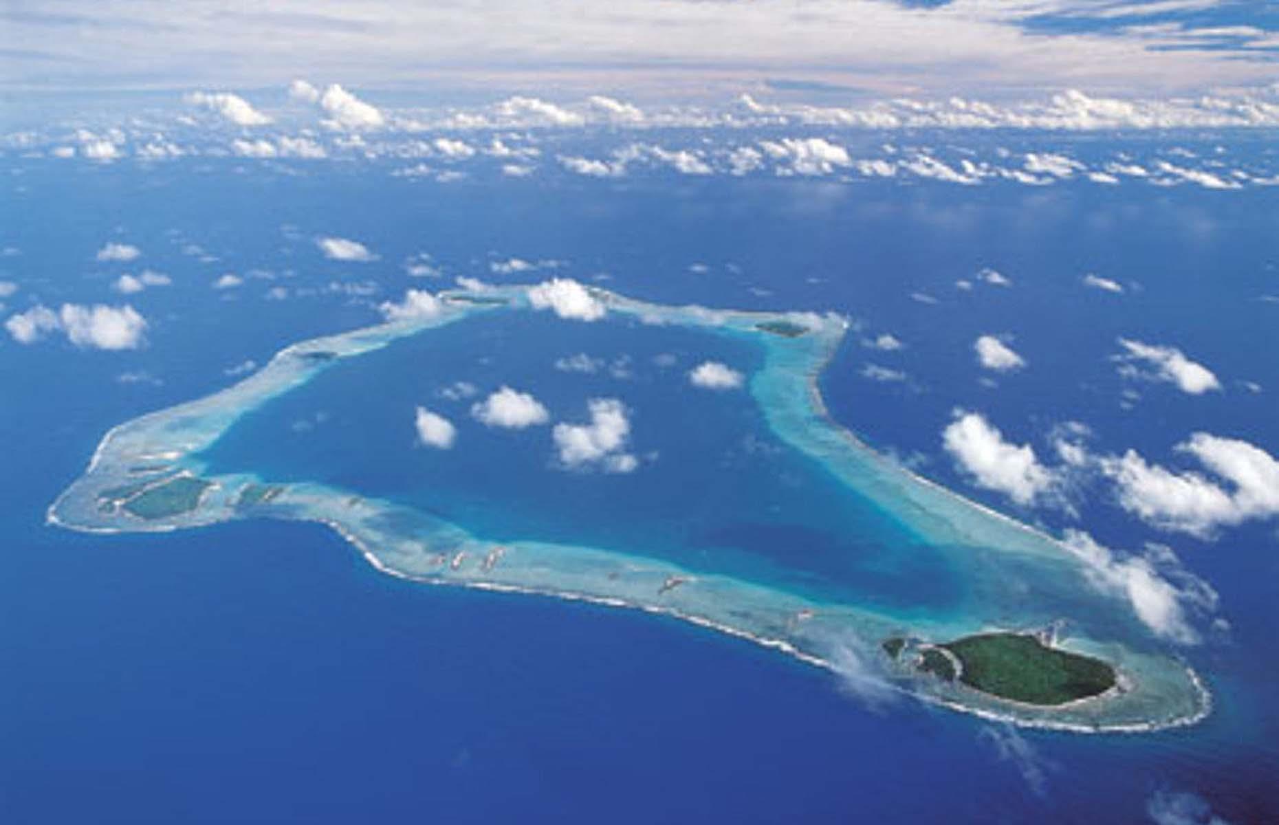 <p>Around 2,000 miles northeast of New Zealand sits the self-sufficient island of Palmerston. One of the 15 Cook Islands, the atoll has a population of less than 60 people, all of whom permanently reside in one of the most isolated communities on the planet. </p>