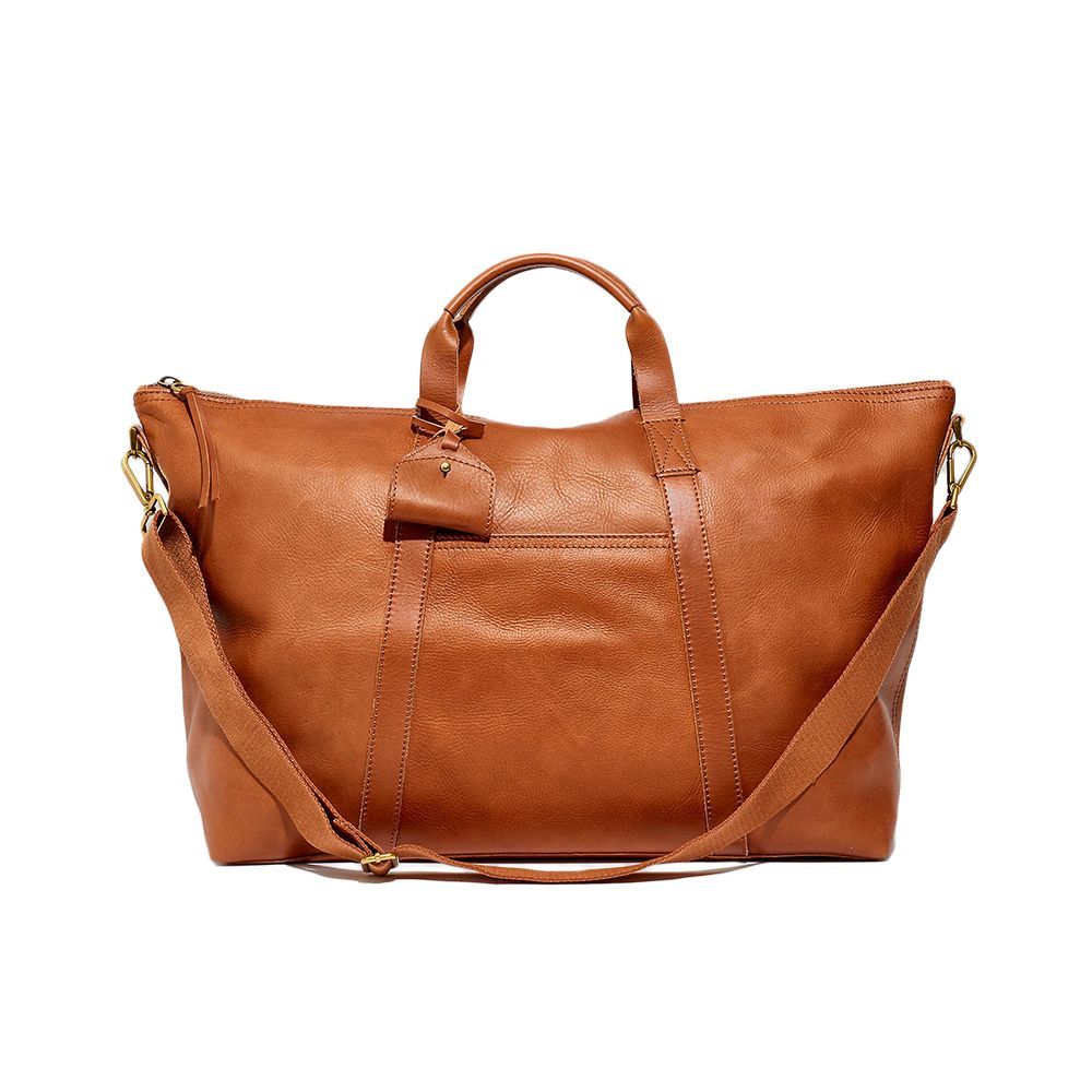 <p><strong>$268.00</strong></p><p>Madewell never ceases to amaze me with its quality. The space and divided compartments within this vegetable-tanned leather tote are ideal for your next overnight adventure. Or, tuck the removable adjustable strap in, and it doubles as a gym bag.</p><p><strong>Dimensions: </strong>Length: 13.375 inches x height: 18 inches x depth: 22.75 3/4 inches</p><p><strong>Color: </strong>English Saddle and True Black</p><p><strong>Material: </strong>Luxe Leather </p>