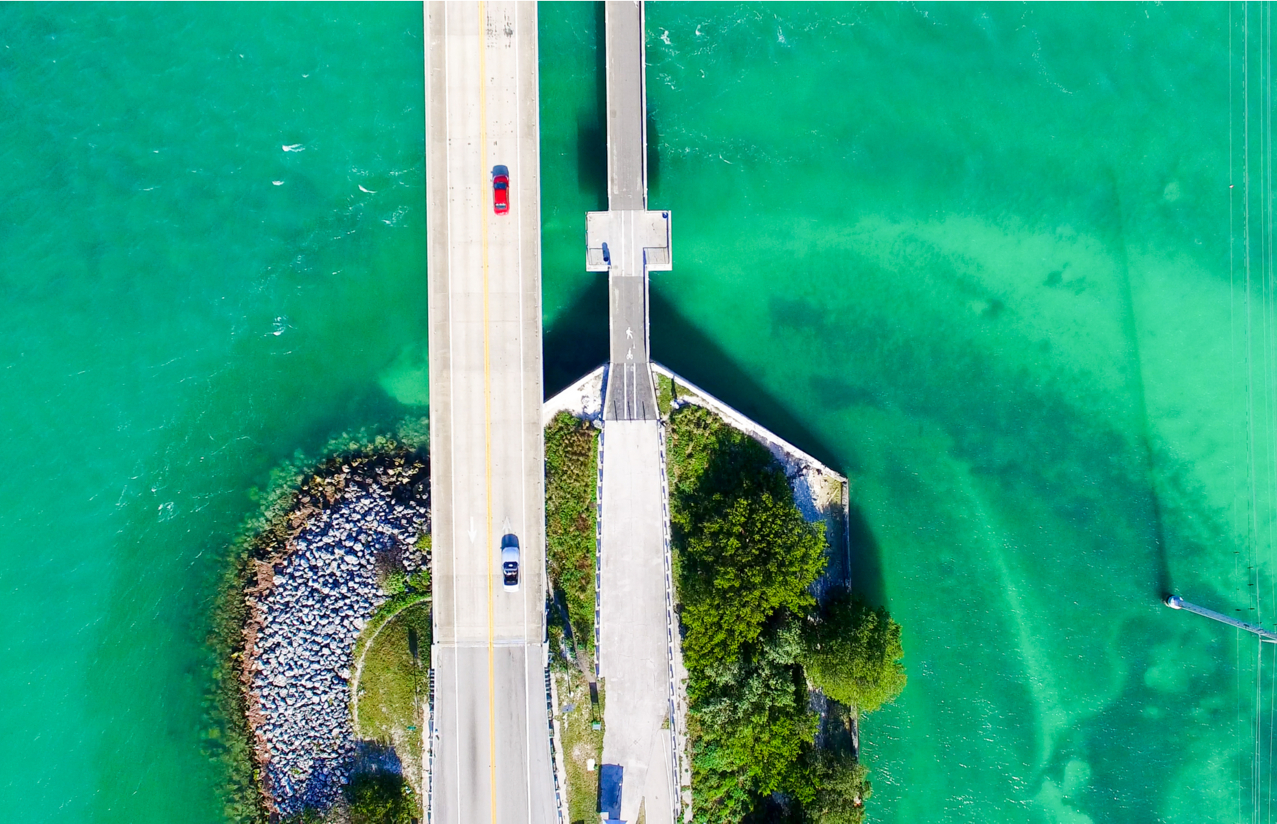 <p>Made famous in commercials and movies, the <a href="https://www.frommers.com/trip-ideas/road-trip/miami-to-the-keys-driving-the-overseas-highway" title="https://www.frommers.com/trip-ideas/road-trip/miami-to-the-keys-driving-the-overseas-highway">Overseas Highway</a> is even more impressive when driven in person. It spans the green-blue seawater in a series of bridges that take you through the Florida Keys. The 150-mile trip is actually the southernmost leg of Highway US 1, and is built on an old, narrow railroad bed so the highway is often just two lanes, making the trip from Miami to Key West between 3.5 and four hours. But the scenery is great and there are a lot of nifty places to stop, so you won’t complain.</p>