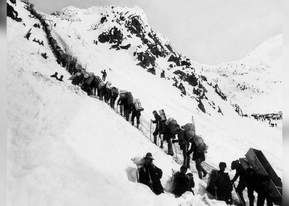 <p><a href="https://www.lib.washington.edu/specialcollections/collections/exhibits/klondike/case7-8">Nicknamed the "Golden Staircase,"</a> Alaska's Chilkoot Pass is a 26-mile trail that took hopeful—and incredibly brave—prospectors through the territory's frigid conditions during the Klondike Gold Rush. This image shows gold diggers trekking along the route in 1898, just two years after gold had been discovered in the Klondike region in 1896. Following the initial discovery of gold, more and more hopefuls attempted to brave the elements—including blizzards, avalanches, and freezing temperatures—to try their hands at finding gold deposits of their own at Klondike.</p>