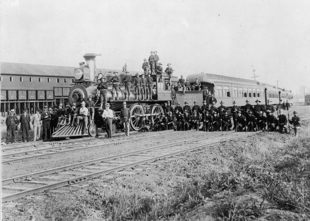 <p>At a point where railroad traffic was thriving and had drastically impacted transportation of individuals and goods across the country, any disruption to the railroads' regular operations had the power to drastically impede day-to-day life. The <a href="https://www.britannica.com/event/Pullman-Strike">Pullman factory strike</a> in 1894 did just that. After having their requests declined during a wage negotiation, factory workers of the <a href="https://thestacker.com/stories/2505/30-victories-workers-rights-won-organized-labor-over-years">Pullman Palace Car Company</a> went on strike. The boycott was extremely detrimental to railroad traffic across the country and resulted in the first instance of government officials and troops getting involved—as seen in this image—to break a strike.</p>