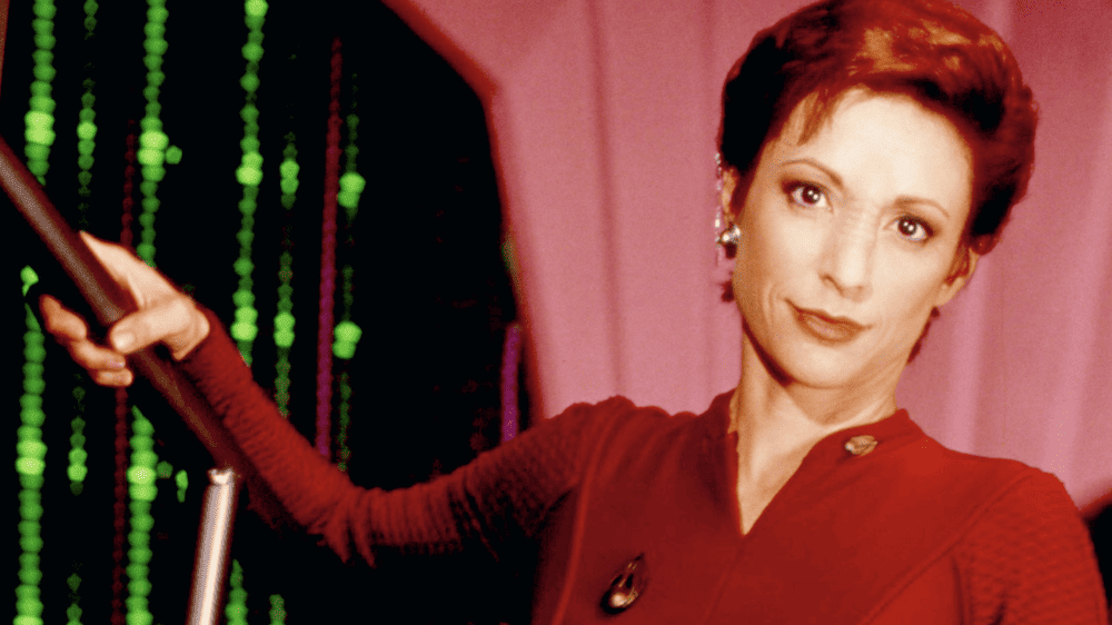 <p><span>Nana Visitor portrayed Major Kira Nerys for the entire 7-season run of </span><i><span>Star Trek: Deep Space Nine</span></i><span>. She is a Bajoran and on DS9, she is the executive officer under the direction of Starfleet Commander Benjamin Sisko (Avery Brooks). Visitor’s character showed nothing but strength and growth as the seasons wore on, putting her in various command positions.</span></p>
