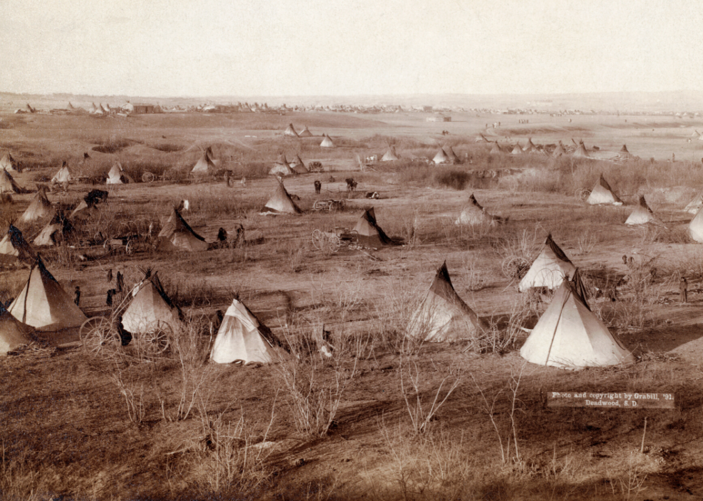 <p>In 1890, the ongoing conflict between the U.S. military and Native Americans erupted on the Lakota Pine Ridge Indian Reservation in South Dakota. <a href="https://plainshumanities.unl.edu/encyclopedia/doc/egp.war.056">Wounded Knee</a> became the site of a massacre—and the final clash between the U.S. government and the Plains Indians—in which 250 Native Americans were killed. This image depicts the landscape of a Lakota village on the Pine Ridge Reservation.</p>