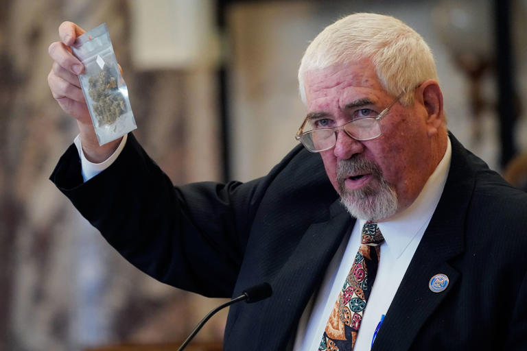 Lead negotiator Kevin Blackwell holds a bag of hemp during his presentation of the Mississippi Medical Cannabis Act in the Senate Chamber at the Mississippi State Capitol in Jackson, on Jan. 13, 2022. The body passed the act.