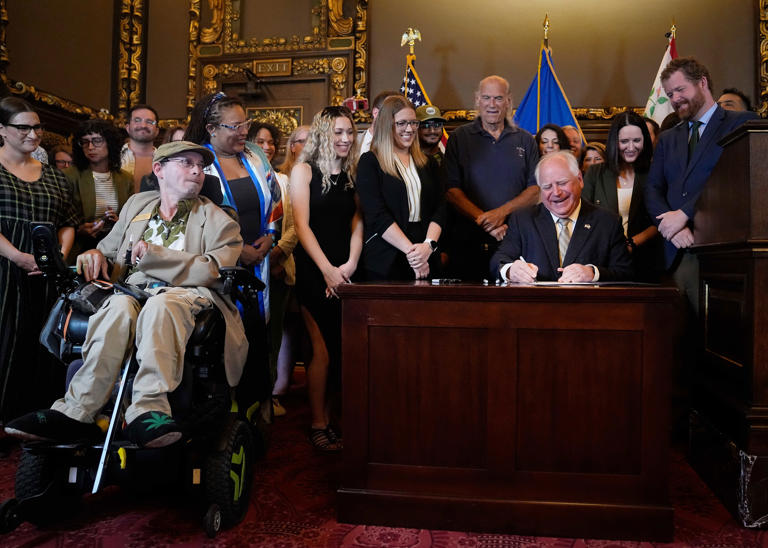 Minnesota Gov. Tim Walz signs a bill to legalize recreational marijuana for people over the age of 21, making Minnesota the 23rd state to do so, on May 30, 2023, in St. Paul.