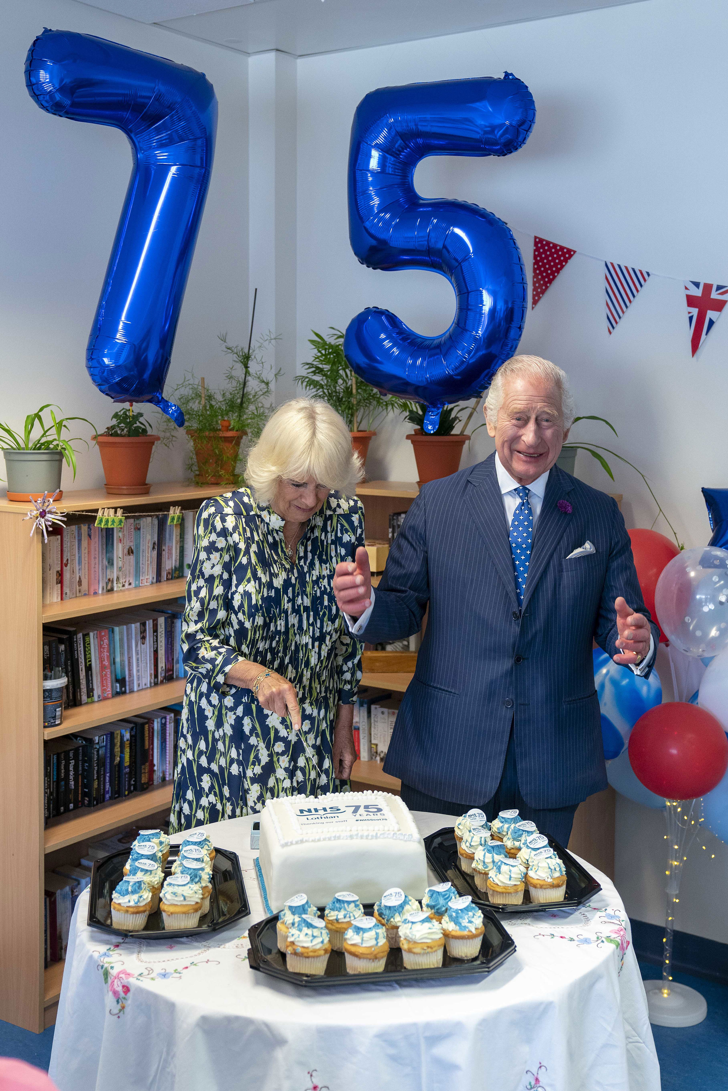 <p>King Charles III and Queen Camilla cut a commemorative cake during a visit to NHS Lothian's Medicine of the Elderly Meaningful Activity Centre at the Royal Infirmary of Edinburgh in Scotland to celebrate 75 years of Britain's National Health Service on July 4, 2023.</p>
