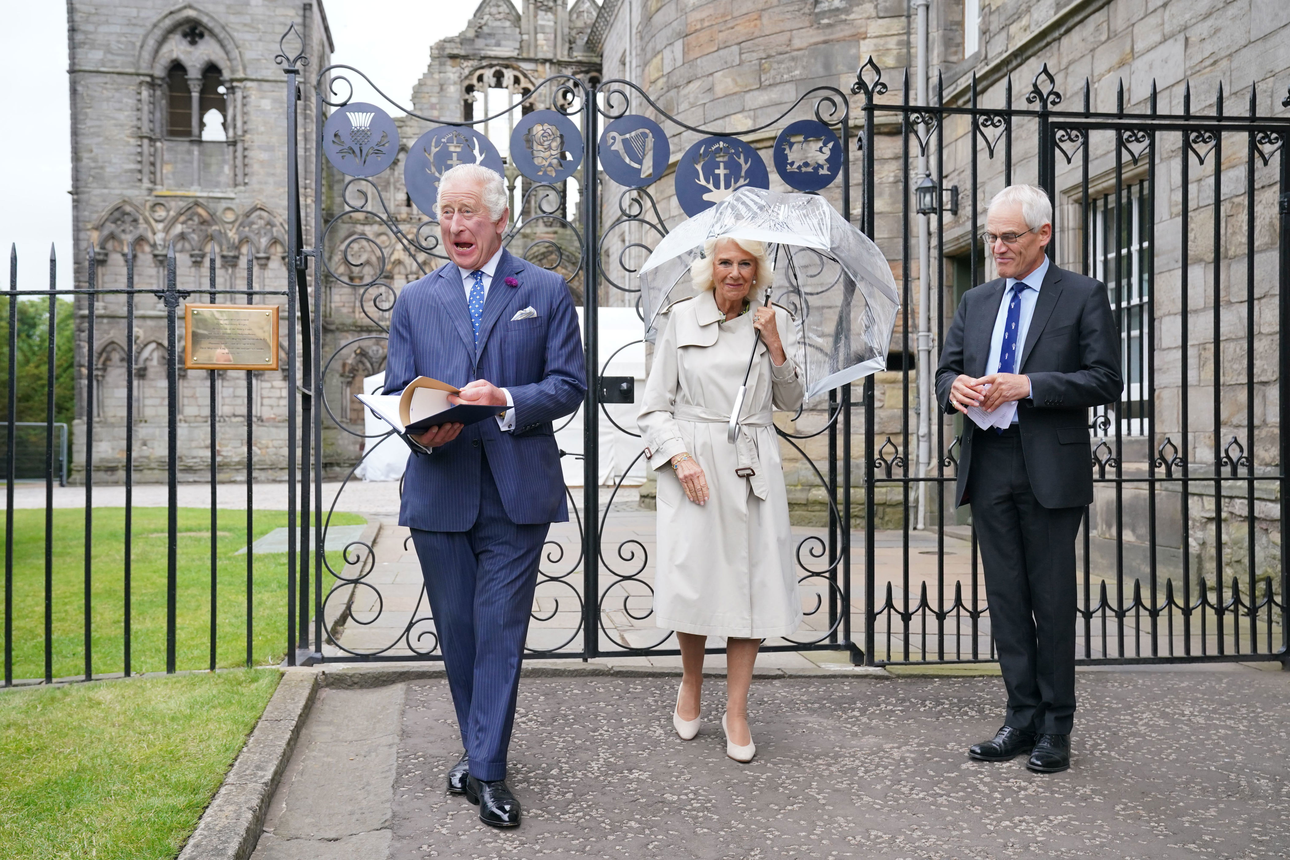 <p>King Charles III looked delighted as he and and Queen Camilla were presented with a leather-bound book detailing the history of Holyroodhouse by moderator of the High Constables Roderick Urquhart as they visited the new Jubilee Gates, installed at the entrance to Abbey Yard to mark the Platinum Jubilee of Queen Elizabeth II, at the Palace of Holyroodhouse in Edinburgh, Scotland, on July 4, 2023.</p>