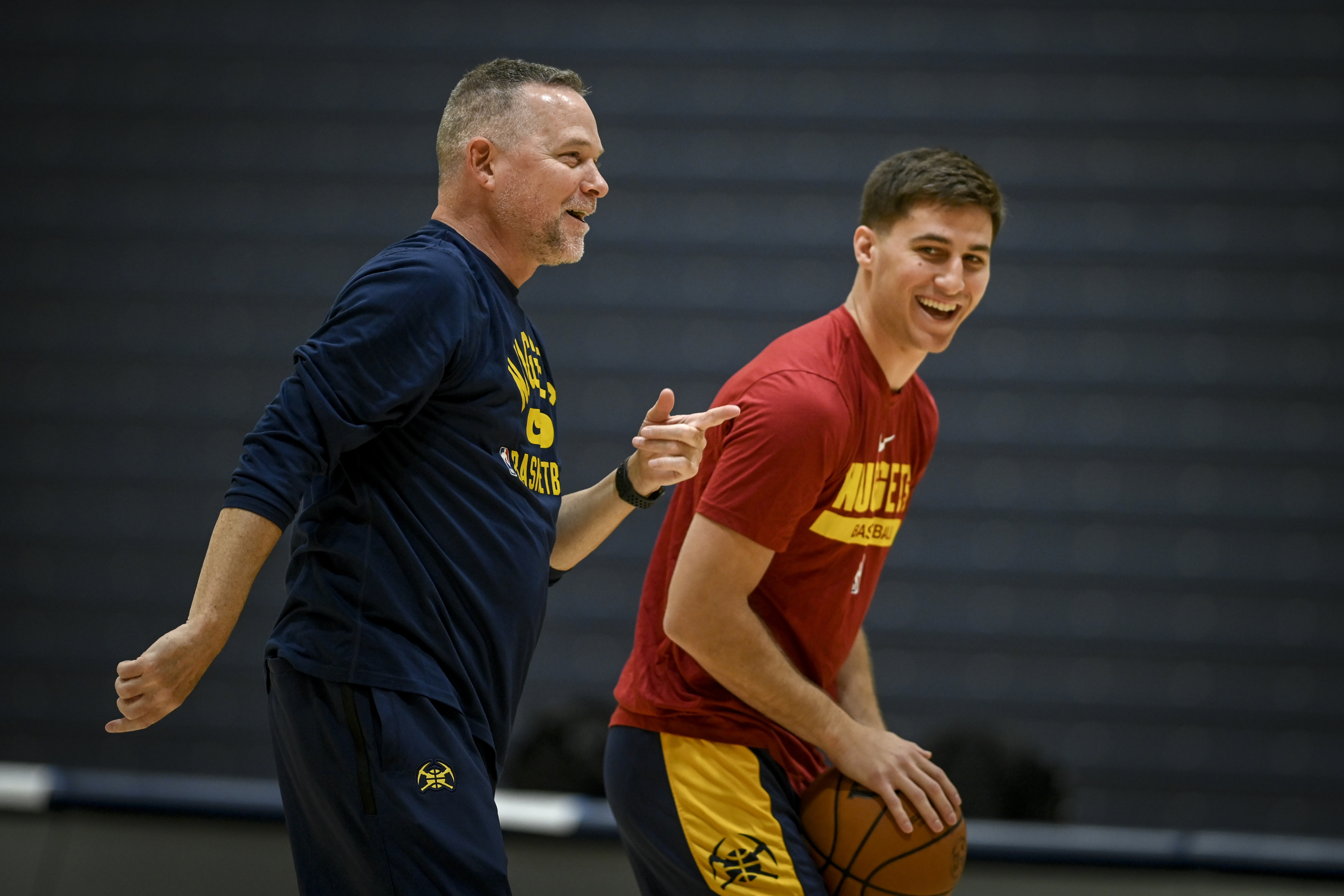 Denver Nuggets head coach Michael Malone shoots and jokes around with Collin Gillespie during the teams training camp at the UCSD campus in La Jolla, California on Wednesday, September 27, 2022.