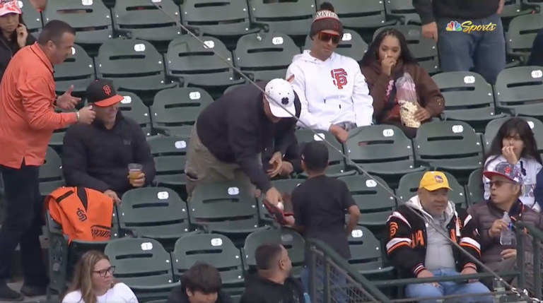 Young San Francisco Giants fan is given a foul ball.