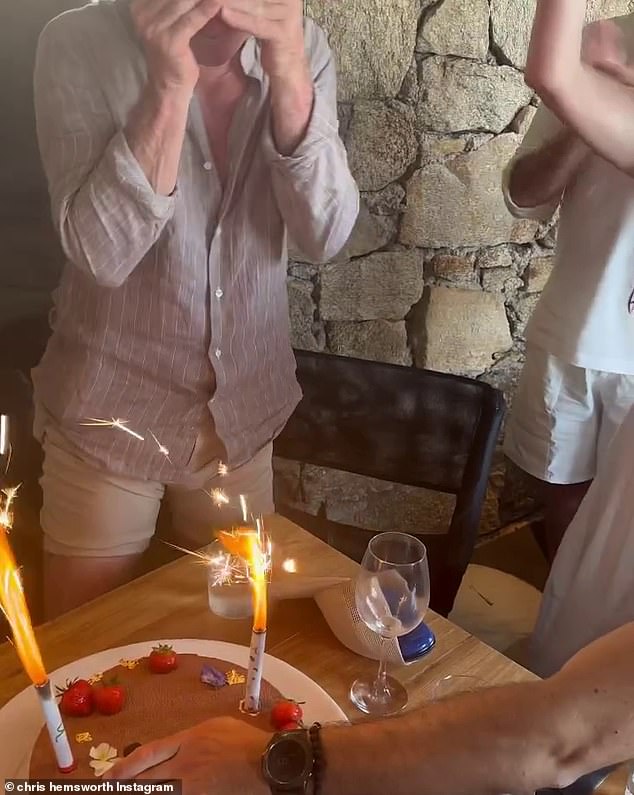 The reel of happy memories began with a joyous video showing the Hemsworth's huddled around a table in the middle of a restaurant, jumping with joy and singing happy birthday around a cake topped with sparklers