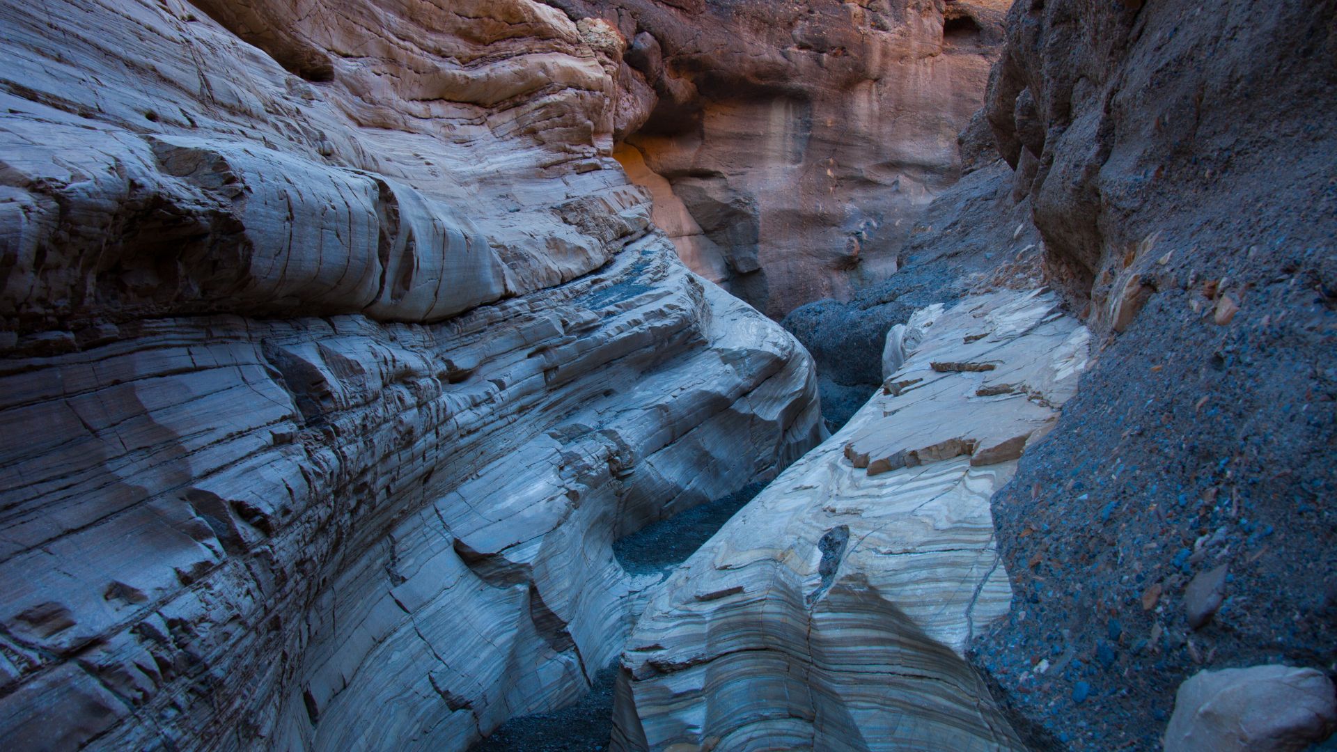 <p>                     <strong>Distance: </strong>3.5 miles<br> <strong>Difficult: </strong>Moderate                   </p>                                      <p>                     Mosaic Canyon is a fascinating slot canyon that gives you a taste of canyoneering without requiring equipment or experience. This canyon is formed of a natural, cement-like substance that holds fragments of many types of rock giving the appearance of small, colorful tiles. The hike starts out with a wide wash but quickly leads you to the exciting, narrow winding passageway of the canyon. Upon encountering a large boulder that appears to be blocking your way, you can turn back or, with a little finesse, squeeze through and keep going. You’ll encounter another such obstacle a little further on but again, you can climb over it and keep going until you reach a small amphitheater where you can enjoy lunch before turning back.                    </p>