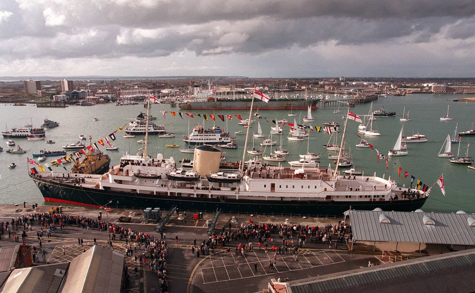 <p><em>Britannia</em> is pictured returning to Portsmouth in November 1997. The vessel would be decommissioned the following month. Thousands of well-wishers lined the shore and gathered at the entrance to the harbor to witness the historic moment as the grand old lady of the seas arrived at the end of her farewell tour of Britain.</p>