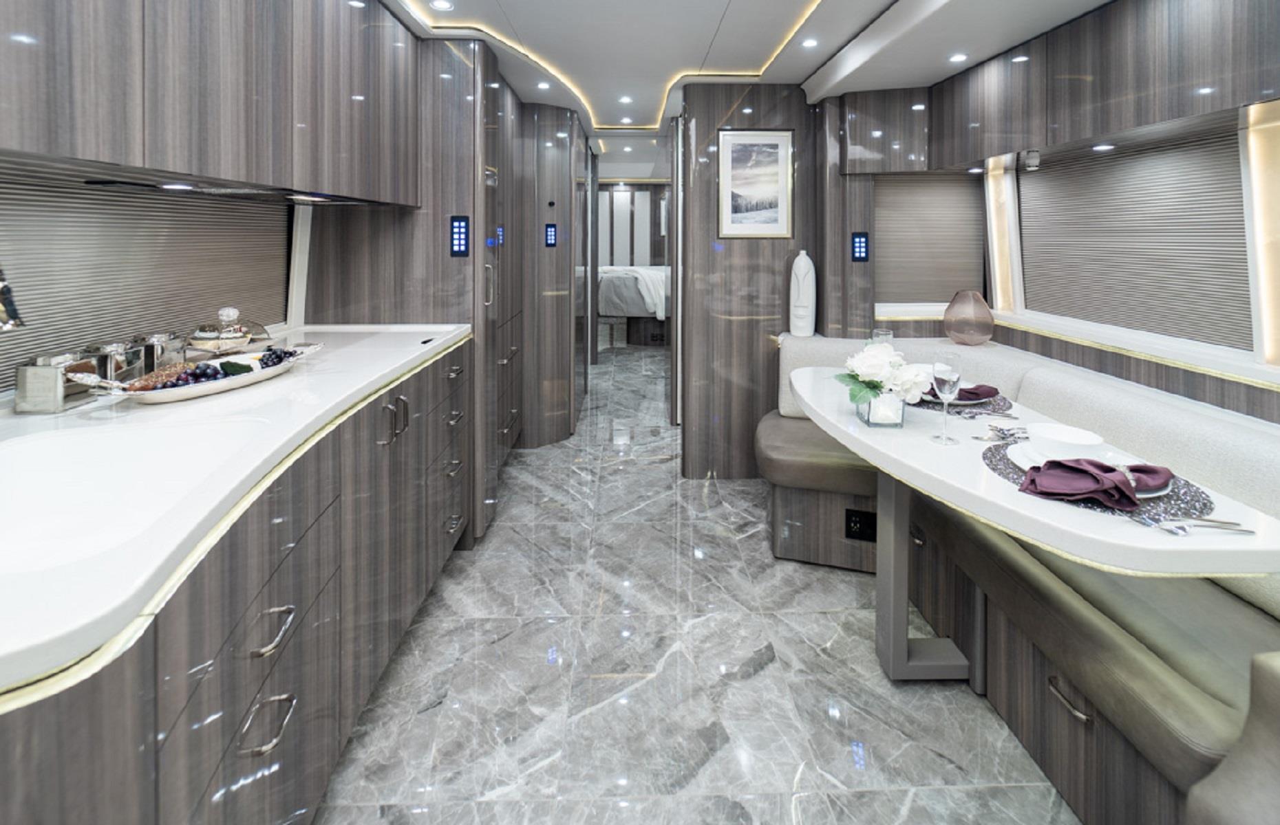 <p>The RV is packed with extravagant amenities and comfort-adding extras, like a fireplace insert in the salon, four air conditioning units and a 360-degree camera system. The kitchen has bespoke built-in storage for your wine bottles, a Sub-Zero refrigerator and a transforming dining table that can extend to host larger gourmet gatherings.</p>