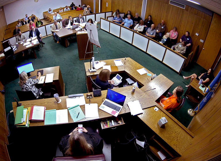 In this screenshot from a security camera recording, Lincoln County District Judge Traci Soderstrom looks at her cellphone during a murder trial in June. Faces of the jurors have been blurred to protect their identities.