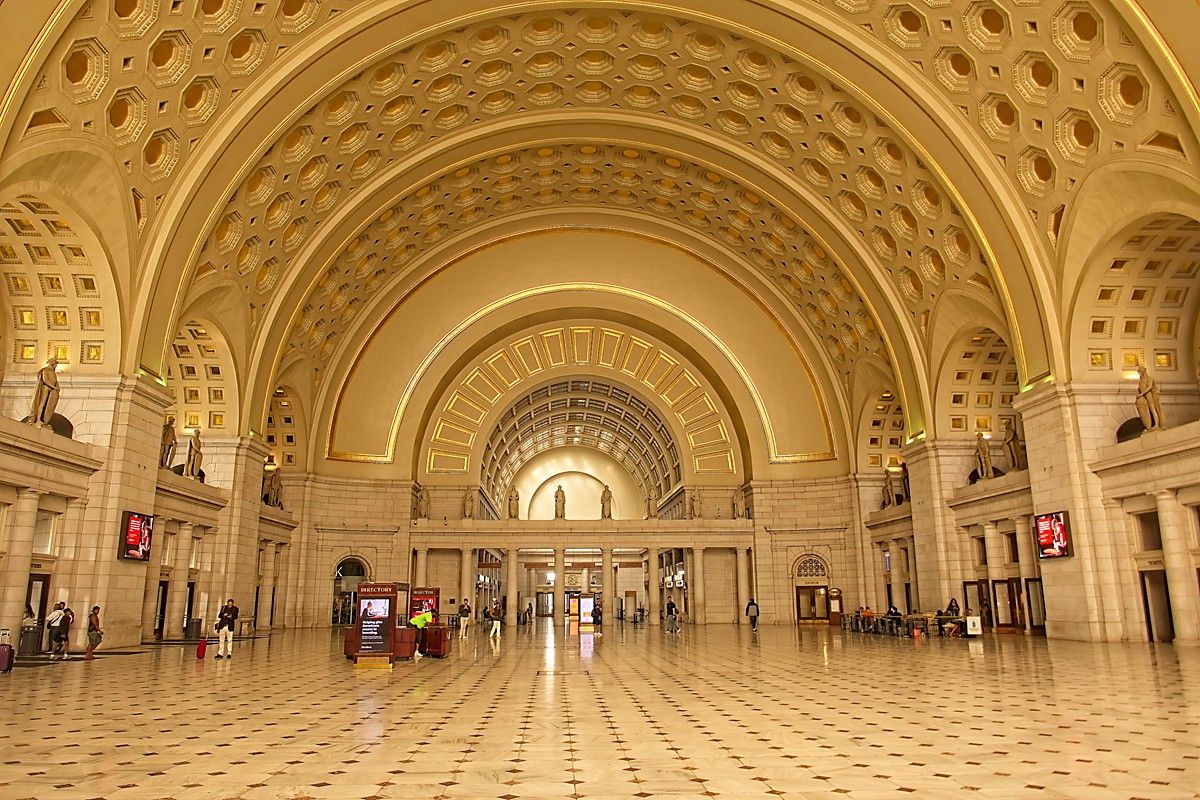 <p>Revered as one of the country’s first great union railroad stations, <a href="https://www.unionstationdc.com/">Union Station</a> in Washington, D.C., is one not to miss. The magnificent terminal features a gilded ceiling and eagle-adorned flagpoles and was completed in 1908, making it over 100 years old. It was designed by Daniel Burnham, a famous architect who drew inspiration for the station from Greek and Roman architecture.</p>