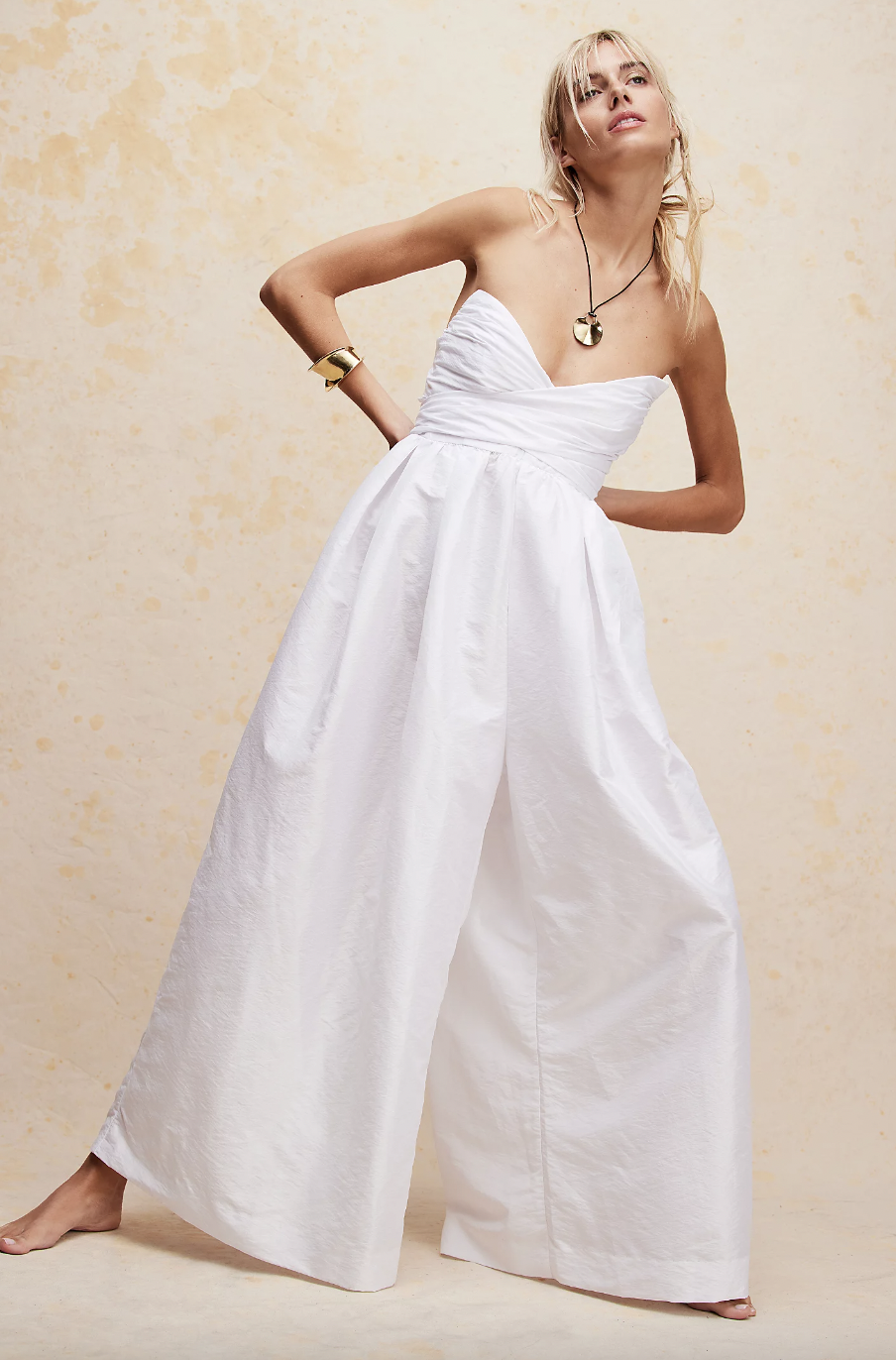 <p><strong>£228.00</strong></p><p><a href="https://www.freepeople.com/uk/shop/jade-jumpsuit2/">Shop Now</a></p><p>Calling all boho brides – we've found the wedding jumpsuit for you. Free People's strapless number features a sweetheart neckline, and a wrap tie-bow detail you can tie at the front or the back. Plus, this baby is a smocked back and suuuper wide-leg pants so is bascially the definition of comfortable. </p>