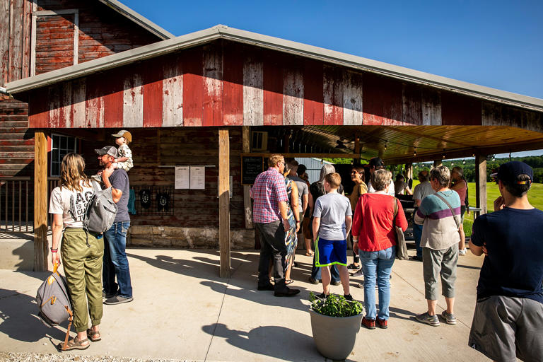 Customers wait in line for their pizzas at Luna Valley Farm, Friday, May 26, 2023, in Decorah, Iowa.