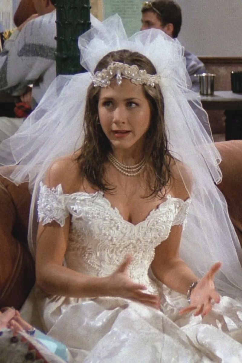 <p>Let’s also not forgot the dress Rachel wore in the <em>Friends</em> pilot, when we meet her after she runs away from her wedding to orthodontist Barry Farber. Please note the fab crown/veil situation here. </p>