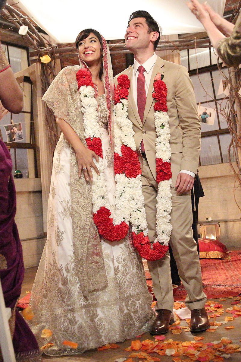 <p>When Cece and Schmidt finally tie the knot on <em>New Girl</em>, Cece wore a pretty gold sari and a red-and-white flower garland, while Schmidt wore a tan suit to match. </p>