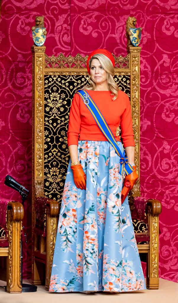 <p>Maxima went for a study in contrasts with an orange top, hat, and gloves paired with a blue floral skirt at the annual opening of the parliamentary year in the Grote Kerk in The Hague.</p>