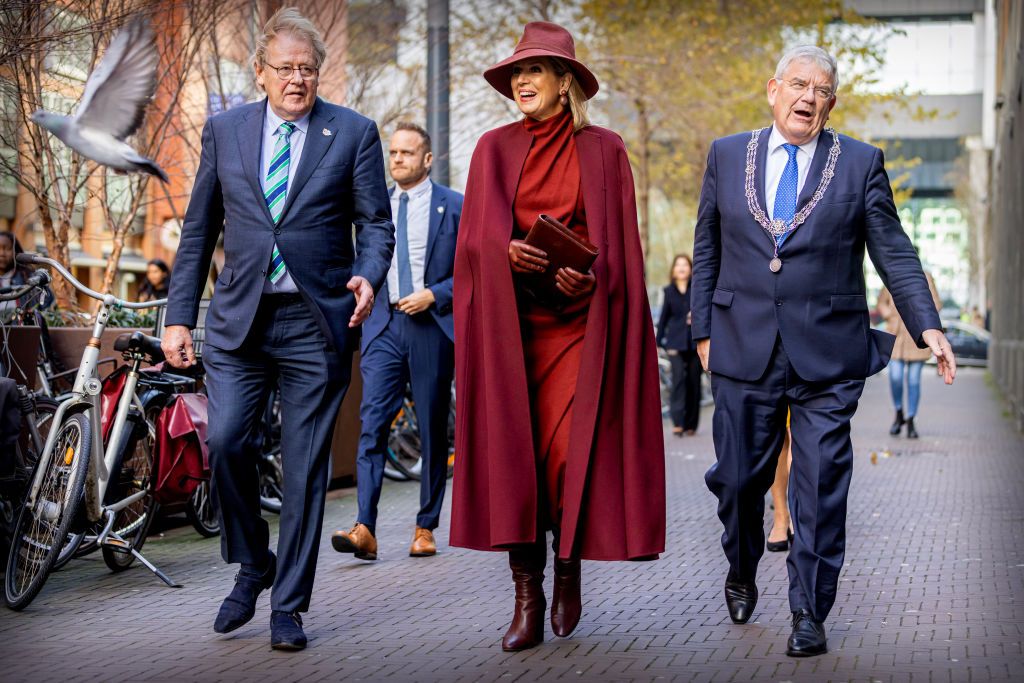 <p>Showing off her mastery of monochrome Queen Maxima wore a merlot cape over a red dress, as well as coordinating boots and gloves, and a clutch and fedora. </p>