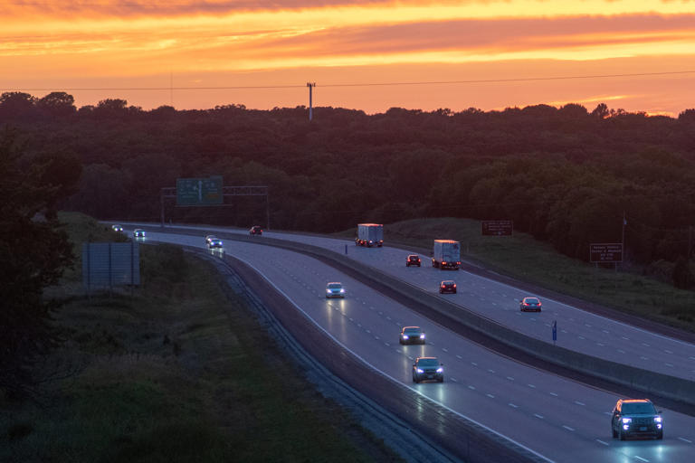 The sun sets over Interstate 70 as vehicles travel through Shawnee County on July 29, 2022.