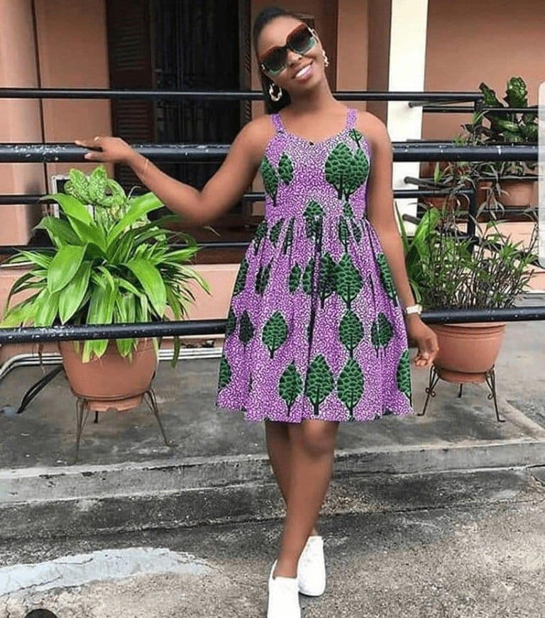 Stylish woman rocking a sleeveless African print pleated dress with white sneakers. Photo: Clipkulture Source: Instagram