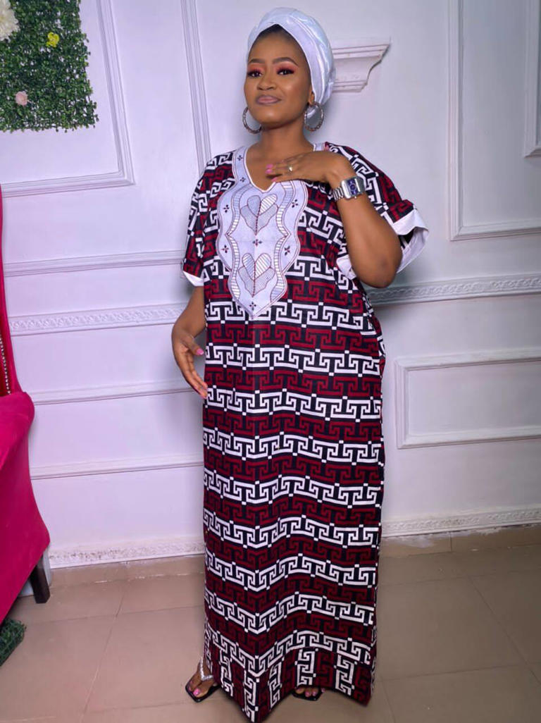 Stylish woman rocking gown with embroidery in her living room. Photo: Selar Source: Instagram