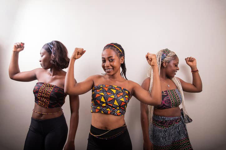 Three African women raise their biceps, concept of strong and empowered women. Photo: Media Lens King Source: Getty Images