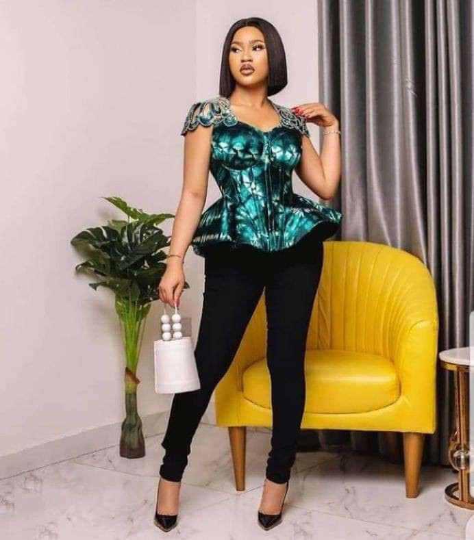 Black woman rocking a stylish peplum top with black trousers. Photo: Kaybee Fashion Styles Source: Instagram