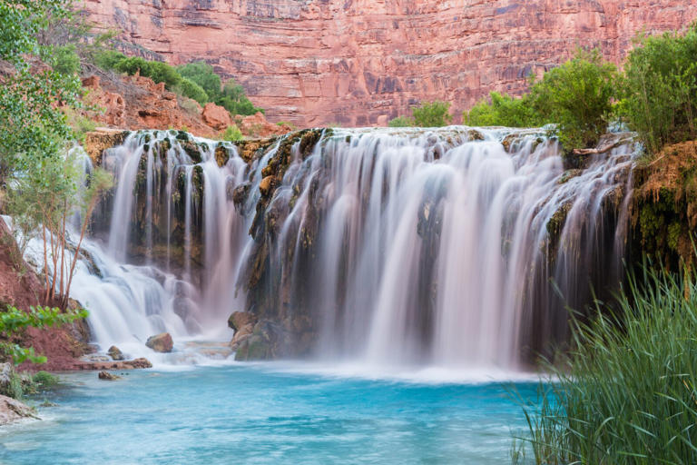 Water flows over Little Navajo Falls into a turquoise pool on the Havasupai Indian Reservation in the Grand Canyon.