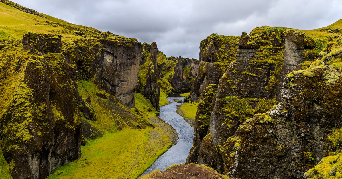 <p> Fjaðrárgljúfur, located in southern Iceland, is a massive serpent-like canyon about 330 feet deep and just over a mile long. </p><p>Hollowed out by the Fjaðrá River over millions of years, the canyon provides stunning views over the plains and glacial brooks below. </p><p>The Fjaðrá River is often low, which makes it possible to walk inside the canyon. If you venture along these paths, prepare for a breathtaking reminder of the power of nature. </p>