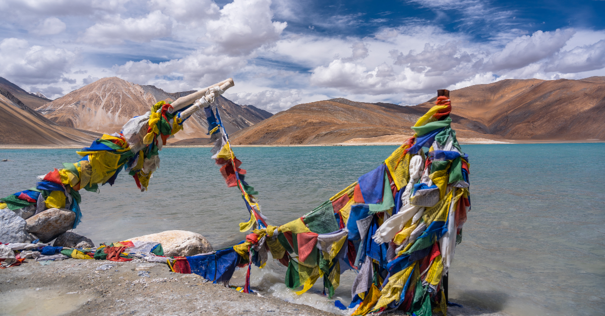 <p> The picturesque Pangong Lake, also known as Pangong Tso, is the world’s highest saltwater lake. </p><p>Extending from India to Tibet and situated in the Himalayas at a dizzying elevation of almost 14,270 feet, the vivid blue water lies in stark contrast to the arid mountains surrounding it. </p><p>The undeveloped landscape, tranquil blue water, and migratory birds that flock to the water make Pangong Lake a natural wonder that won’t disappoint.   </p>