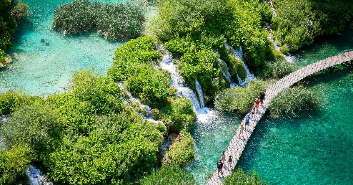 <p> Plitvice Lakes National Park is a forest reserve and UNESCO World Heritage site spanning roughly 115 square miles in central Croatia. The park is situated about halfway between Croatia’s capital city, Zagreb, and the ancient coastal city of Zadar.</p><p>The park is known for its chain of 16 lakes, interconnected by a series of waterfalls. Formed throughout thousands of years, the lakes are a stunning place to visit no matter the time of year. </p><p>Whether they’re surrounded by the lush greenery of spring and summer, the rich colors of autumn, or the magical scenes of winter.</p>