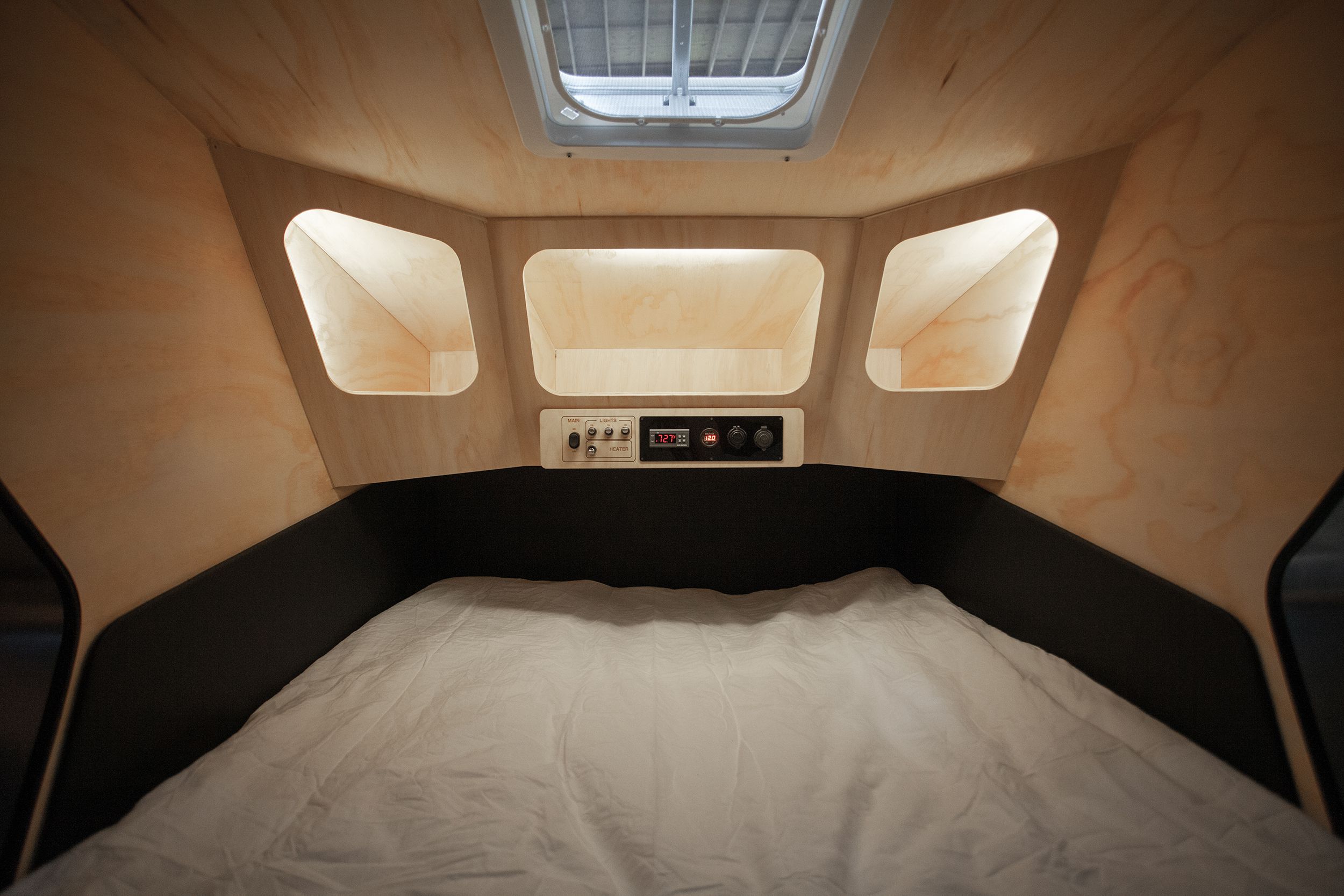 <p>Like other trailers with similar profiles, the Polydrop includes a cabin with sleeping space and storage, and the camper's back opens up to a minimalist, mod-looking cooking space that includes a cabinet for electronic components and two storage drawers — no cooktop, sink, or refrigeration here. Polydrops start at $12,500.</p>