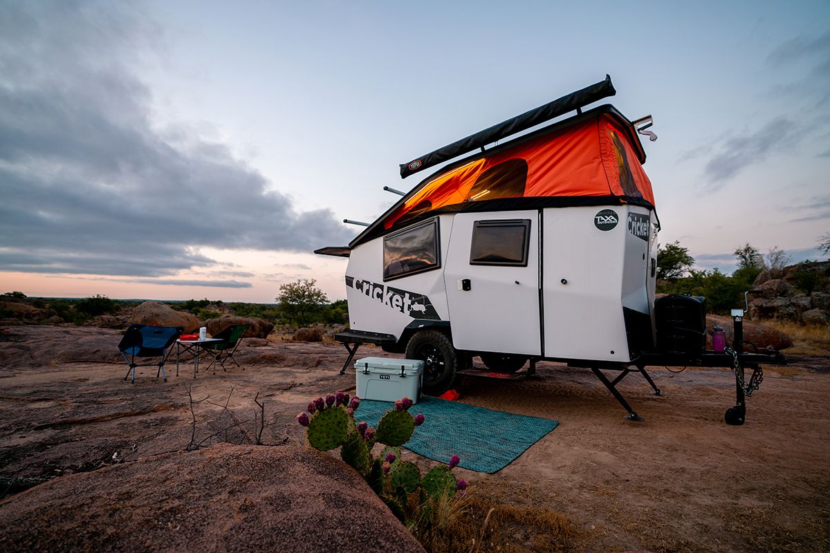 <p>With a dry weight of just over 1,700 pounds and a design inspired by NASA, the <a href="https://taxaoutdoors.com/products/cricket">easily towable Cricket</a> has a ton of features that make this tiny RV versatile. Once parked, campers can open a pop-up roof for added ventilation and space. It also comes with a built-in, birch plywood kitchen, under-bed storage, and a bed that can be converted into seating.  </p>