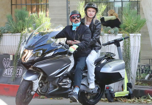 Anthony, vocalist of the Red Hot Chili Peppers. He is on a touring date with his younger girlfriend on a custom BMW motorcycle designed in the image of a killer whale.
