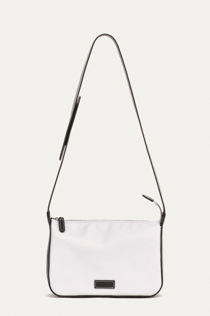 <p><strong>€431.00</strong></p><p><a href="https://www.tl-180.com/bags/la-forti-nylon-nappa-bianco-nero/">Shop Now</a></p><p>One of my personal favorite handbag brands, TL 180, comes from a cool female design duo based in Rome. They introduced nylon into their usual leather offerings a few years ago, and I haven't been able to take my La Forti bag every since. <br><br>The fabric is super lightweight and easy to throw around, especially when traveling. The unstructured nature of the material also means a lot can fit inside. I like that this shape can be worn as a crossbody <em>or</em> a shoulder bag, depending on my mood. </p><p><strong>Materials:</strong> 100% Nylon and Nappa Leather </p><p><strong>Dimensions:</strong> 7" H x 1o" W x 8.5" D; shoulder strap with 17" drop. </p><p><strong>Colors:</strong> White and Black </p>