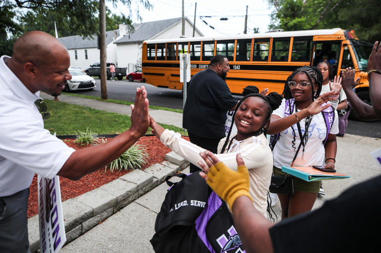 Students get greeted with high-fives at the entrance to J. Blain Hudson Middle School in the California neighborhood on the first day of classes Wednesday morning, Aug. 9, 2023.