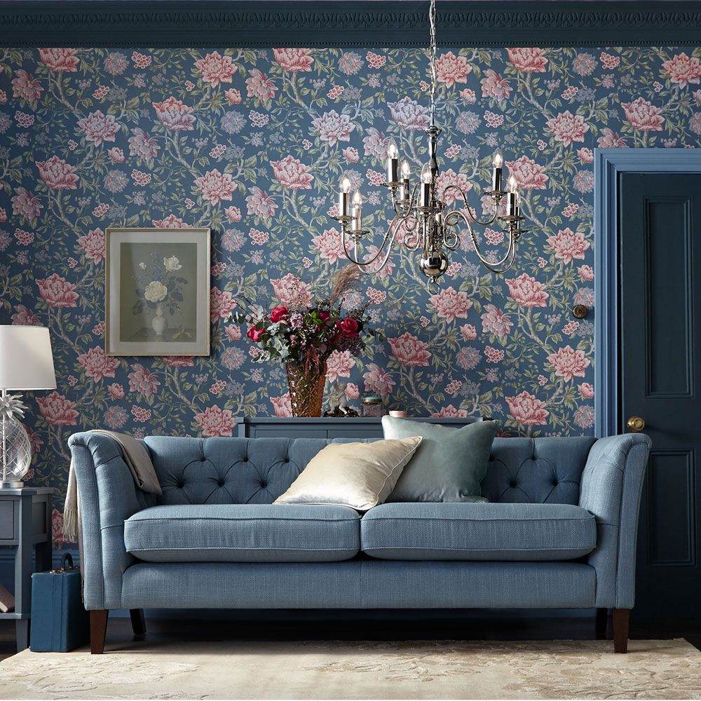 <p>                     Dip a toe into a maximalist look with a feature wall, or go for total drama by using living room wallpaper on all four walls. The dusky, restful shade and the tonal blue sofa, woodwork and furniture, softens the overall look so the busy print won’t overwhelm the space.                   </p>                                      <p>                     A contemporary twist on a traditional Chesterfield, the button back sofa bring a modern silhouette whilst still maintaining classic grandeur to complement the heritage wallpaper.                   </p>