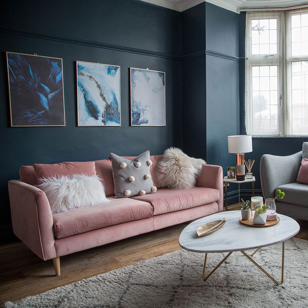 <p>                     Backed by any other shade, this pink sofa might look a little too sugary for many people's taste. But with a dark inky blue behind it, it's the ultimate in sophistication, enhanced by the coffee table's brass legs and accessories.                   </p>                                      <p>                     Also framed in brass are three blue prints, which break up the blue without detracting too much from its effect. Warm wood flooring and a pale rug keep things bright yet cosy underfoot.                   </p>
