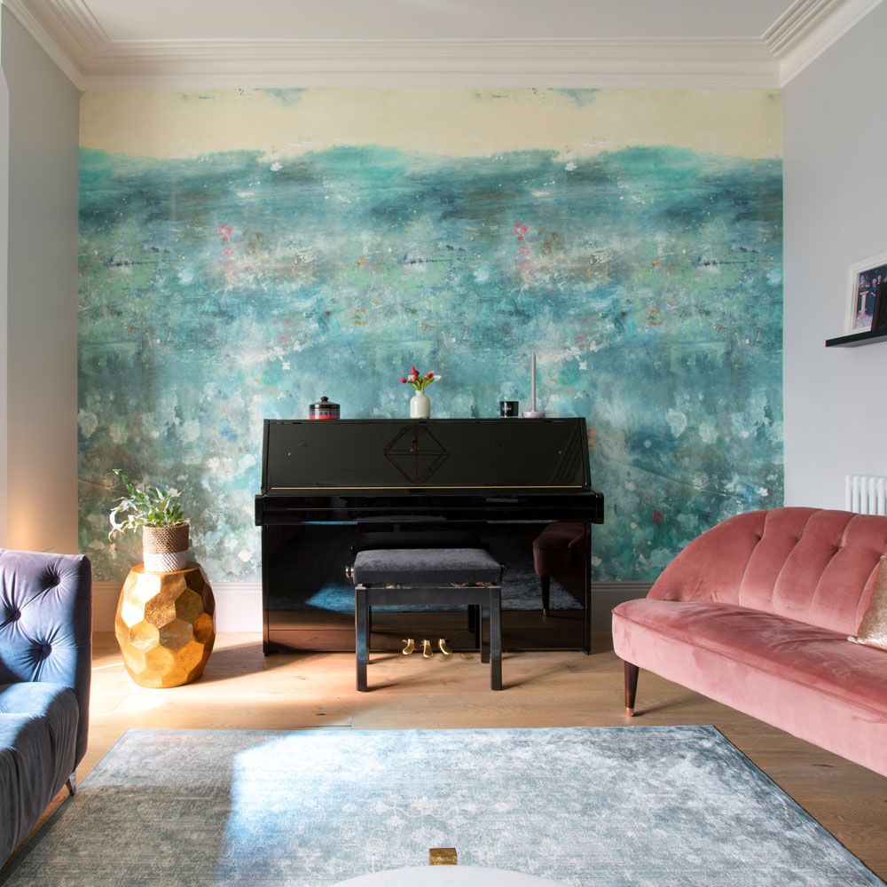 <p>                     Set the scene for your blue living room with a feature wall. This striking wall mural has an 'under the sea' vibe that creates a lush serene feel to the overall scheme, which is already tranquil with pale blue-grey walls with a light grey rug and gentle pink sofa to contrast.                   </p>