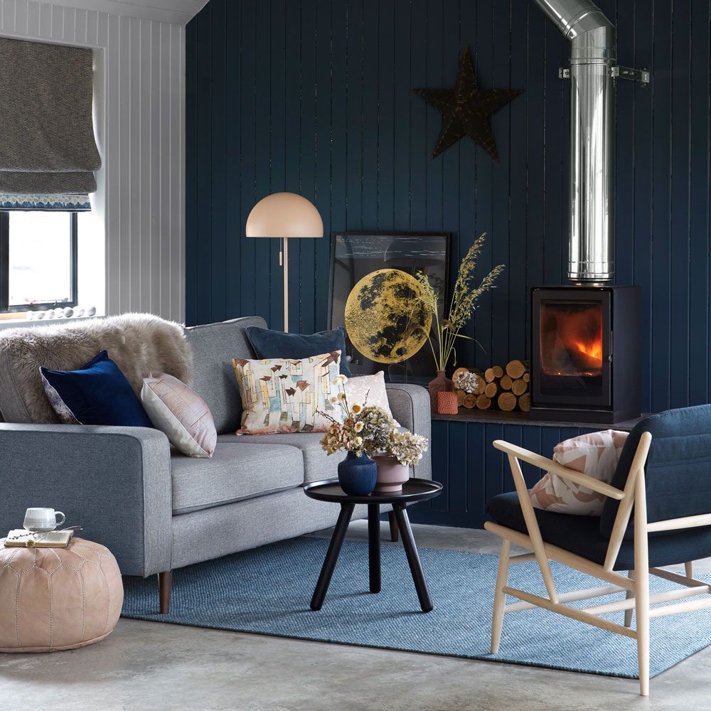 <p>                     You might think of blue as a cool colour, but the deepest, darkest shades will create a cosy, cocooning look, as evidenced here.                   </p>                                      <p>                     Greys and blush pinks are the ideal bedfellows – or should that be sofa fellows? – for this opulent midnight shade. They both soften and brighten up the room, while a woodturning stove, tongue and groove panelling and pale wood furniture enhance the rustic feel.                   </p>